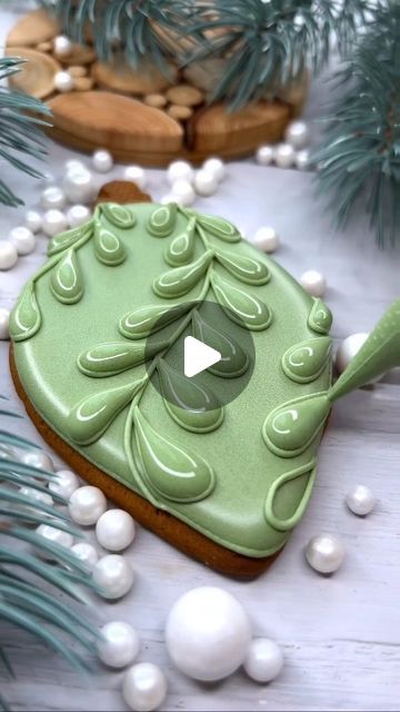 Elegant Leaf-Shaped Cookie with Glossy Green Icing on Minimalistic Backdrop