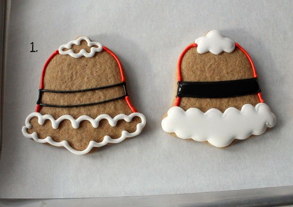 Festively Iced Gingerbread Bell Cookies with Intricate Scalloped Designs in Red and White.