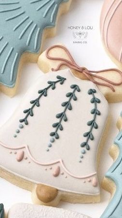 Intricately Iced Holiday Cookies Featuring Festive Bell Designs and Complementary Colors.