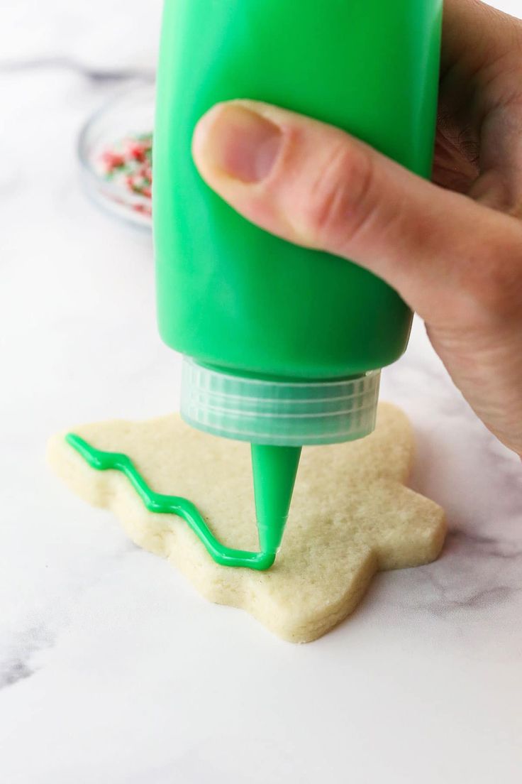 Festive Christmas Tree Cookie Decorated with Vibrant Green Frosting and Sprinkles.