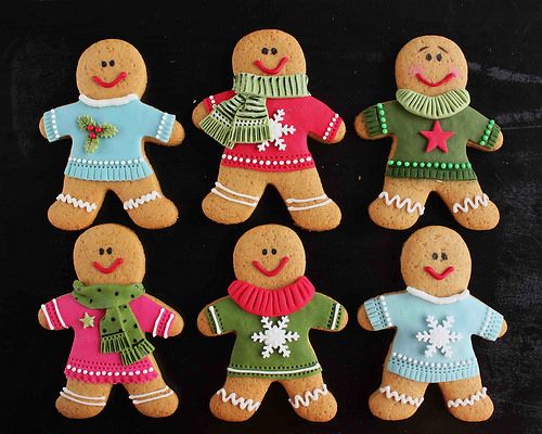 Whimsical Holiday Gingerbread Cookies Adorned in Cheerful Sweater Designs.