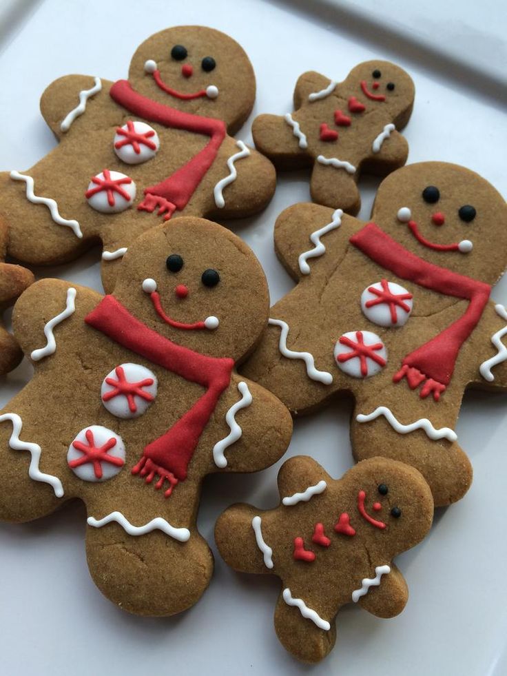 Festive Gingerbread Cookies: Colorfully Iced with Adorable Faces and Peppermint Patterns.