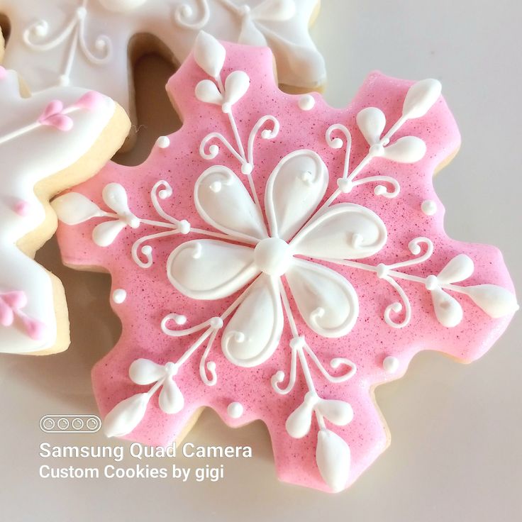 Whimsical Winter Nail Art: Elegant Pink Snowflake Design with Intricate White Piping