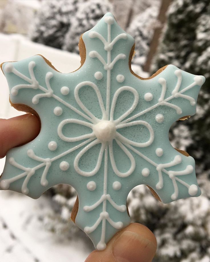 Icy Blue Snowflake Nail Design with Elegant White Detailing for a Wintery Vibe.