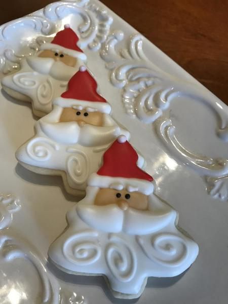 Cheerful Santa Claus-Shaped Festive Cookies with Colorful Icing.