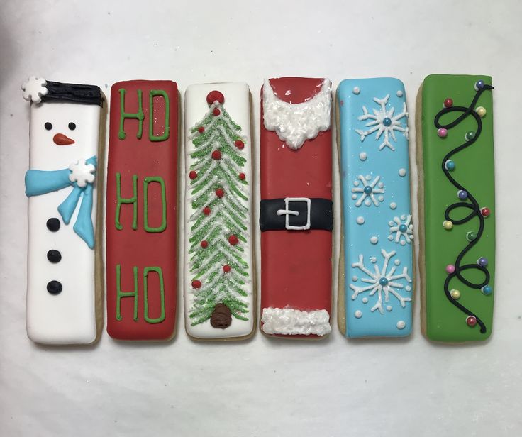 Winter-Themed Festive Cookies Featuring a Cheerful Snowman, Decorated Christmas Tree, and Jolly Santa Suit in Vibrant Colors.