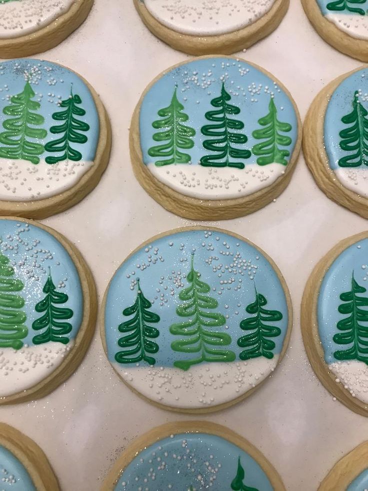 Whimsical Winter Cookies Featuring Hand-Painted Evergreen Trees and Snowflake Sprinkles.