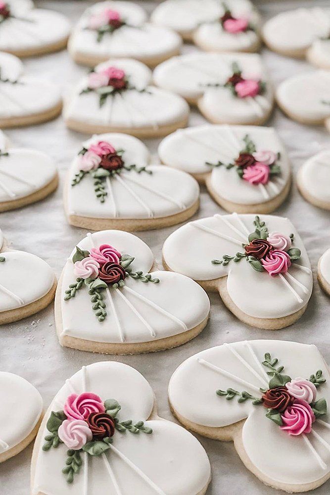 Charming Heart-Shaped Cookies Adorned with Floral Designs for Romantic Occasions.