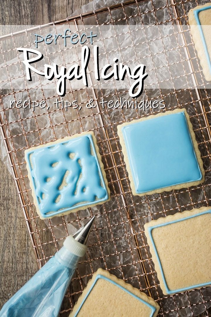 Elegant Royal Icing Designs: Soft Blue Glaze and Intricate Piping on Rectangular Cookies.