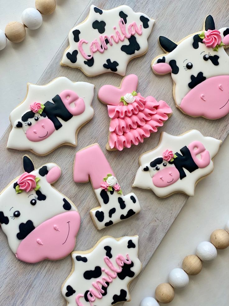 Charming Playful Cow-Themed Cookie Designs with Festive Pastel Colors and Floral Accents.