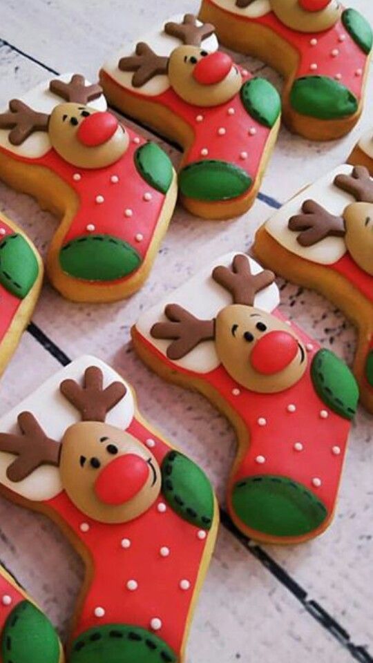 Whimsical Holiday Stocking Cookies: Colorful Treats Adorned with Cheerful Reindeer Faces.