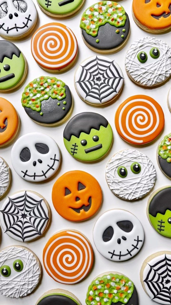 Vibrant Halloween Cookies Adorned with Spooky Faces and Whimsical Designs.