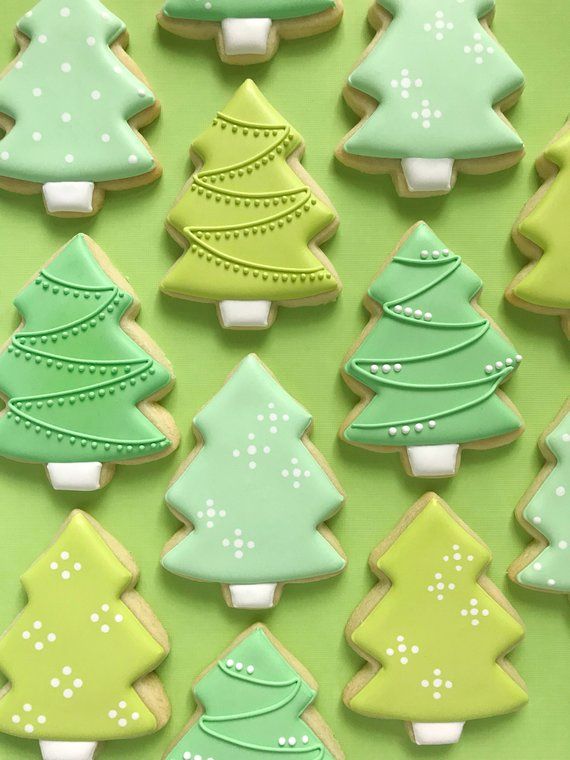 Charming Festive Cookie Designs with Intricate Green Tree Patterns for Holiday Celebrations.