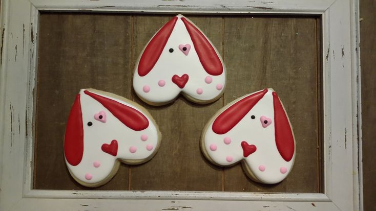 Whimsical Heart-Shaped Dog Cookies with Playful Icing Designs for Celebrations.