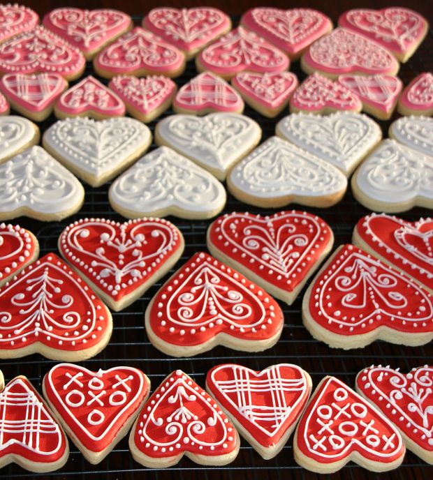 Romantic Heart-Shaped Cookies with Intricate Icing Designs for Special Occasions.