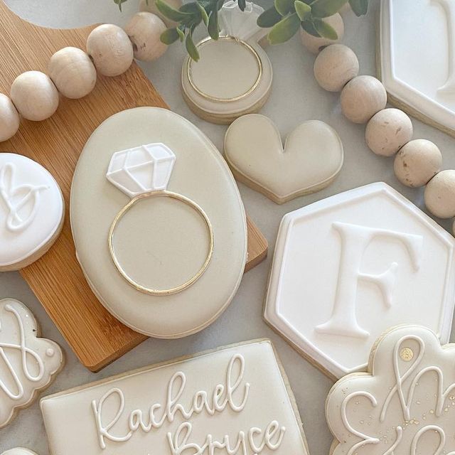 Elegant Cookie Decorations: Sophisticated Designs and a Diamond-Embellished Ring for Celebrations.