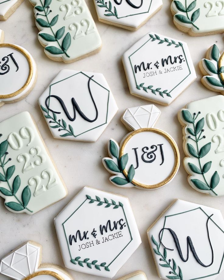 Sophisticated Wedding Cookies: Elegant Designs with Personalized Accents and Greenery.