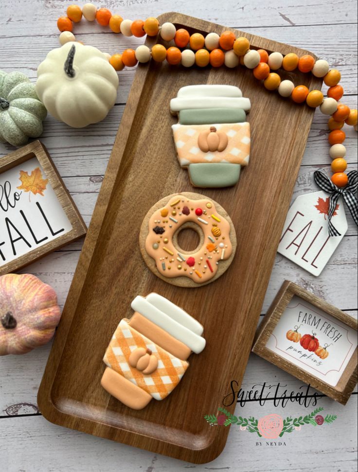 Charming Autumn Treats Display with Decorated Cookies and Festive Coffee Cups