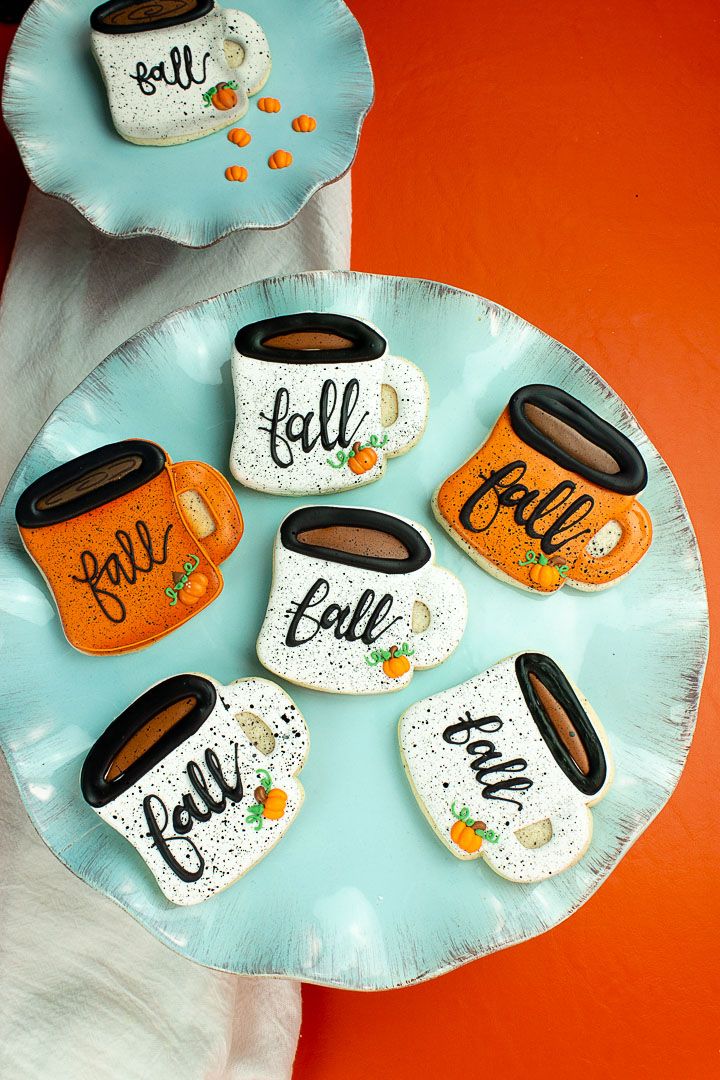 Cozy Autumn Cookie Designs: Adorable Mug Creations with Warm Colors and Playful Patterns