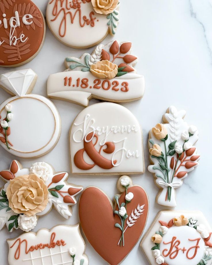 Elegant Wedding Cookie Decorations with Floral Designs and Romantic Calligraphy.