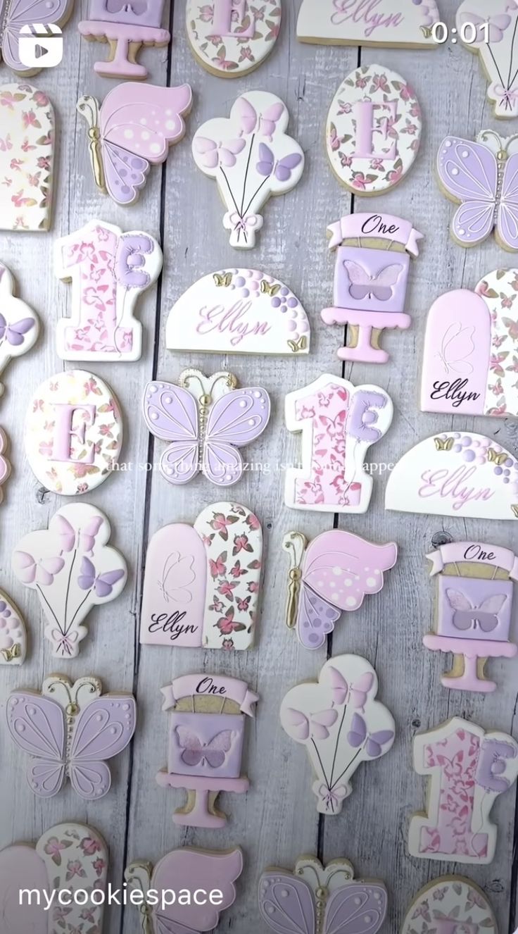 Whimsical Pastel Cookie Designs Featuring Elegant Butterflies and Balloons for First Birthday Celebrations.