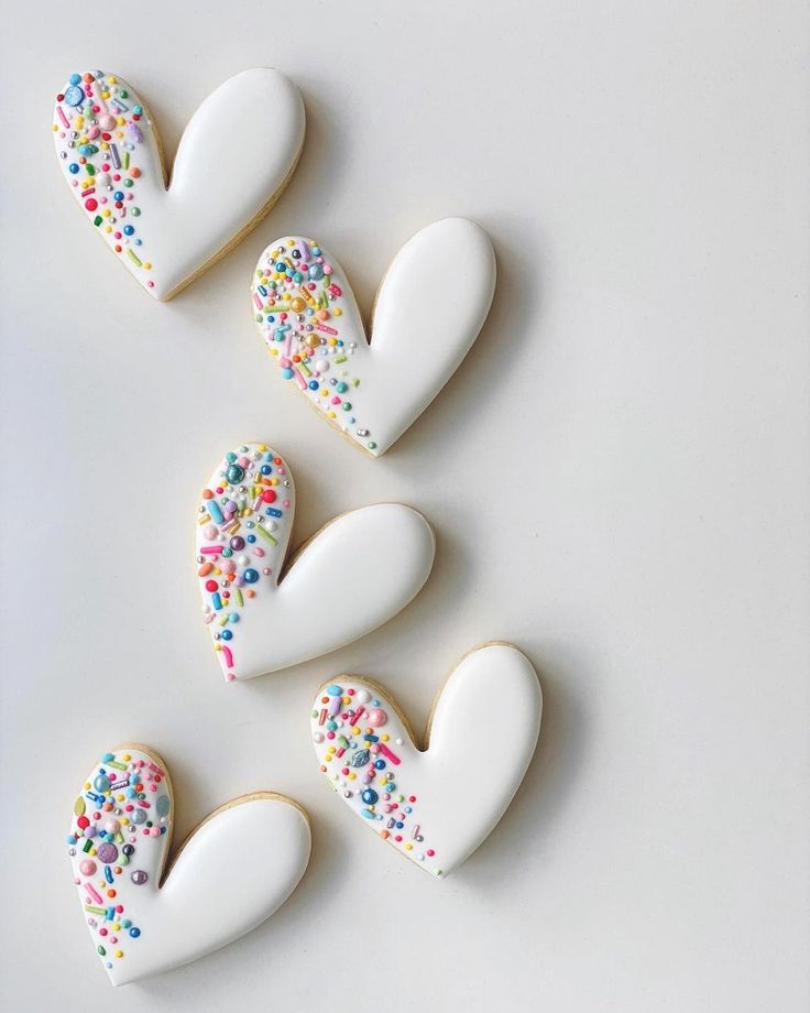 Whimsical Heart-Shaped Cookies Topped with Colorful Sprinkles for Festive Occasions.