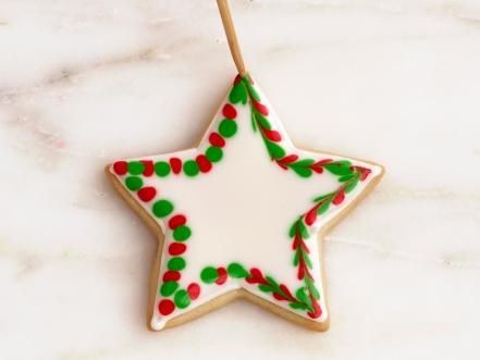 Festive Star-Shaped Cookie Design: Vibrant Icing and Cheerful Holiday Motifs for Nail Art Inspiration.