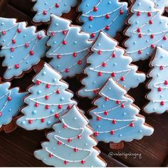 Whimsical Festive Tree-Shaped Cookies with Light Blue Icing and Cheerful Holiday Accents.