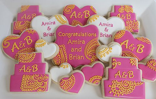 Festive Heart-Shaped Cookies: Vibrant Pink and White with Intricate Gold Details for Celebrations.