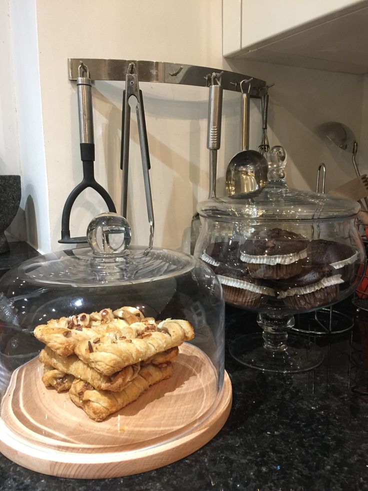 Elegant Pastry Display: Golden Croissants Under Glass Dome in Modern Kitchen.