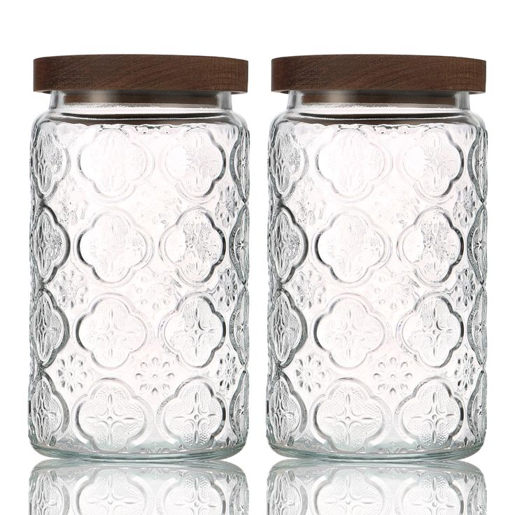 Elegant Decorative Glass Jars with Embossed Patterns and Rustic Wooden Lids for Stylish Storage and Display.