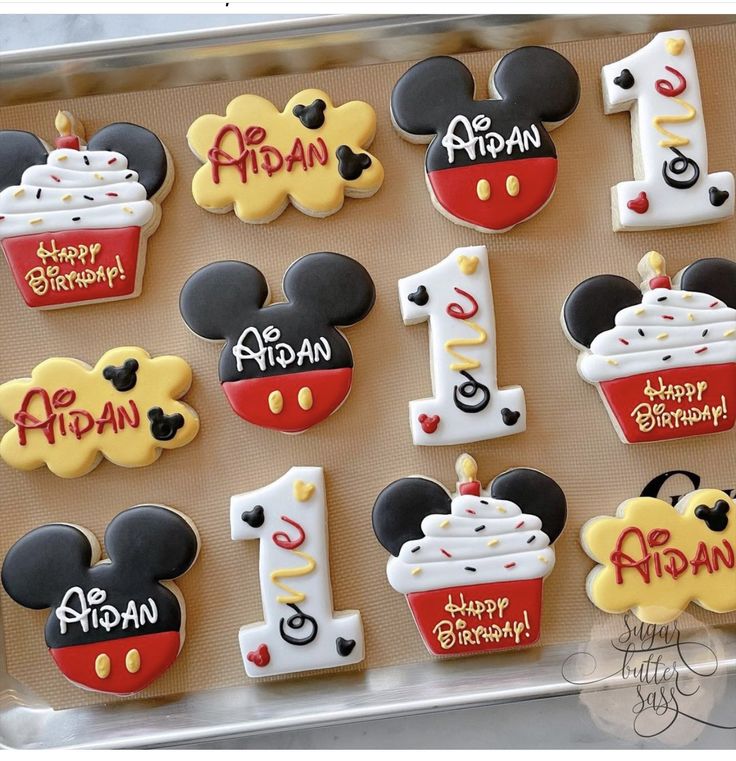 Playful Birthday-Themed Colorful Cookie Designs with Mickey Mouse and Festive Cupcakes.