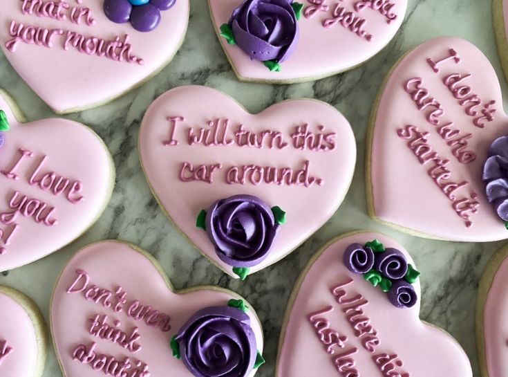 Charming Heart-Shaped Cookies with Pastel Icing and Whimsical Phrases Enhance Special Occasions