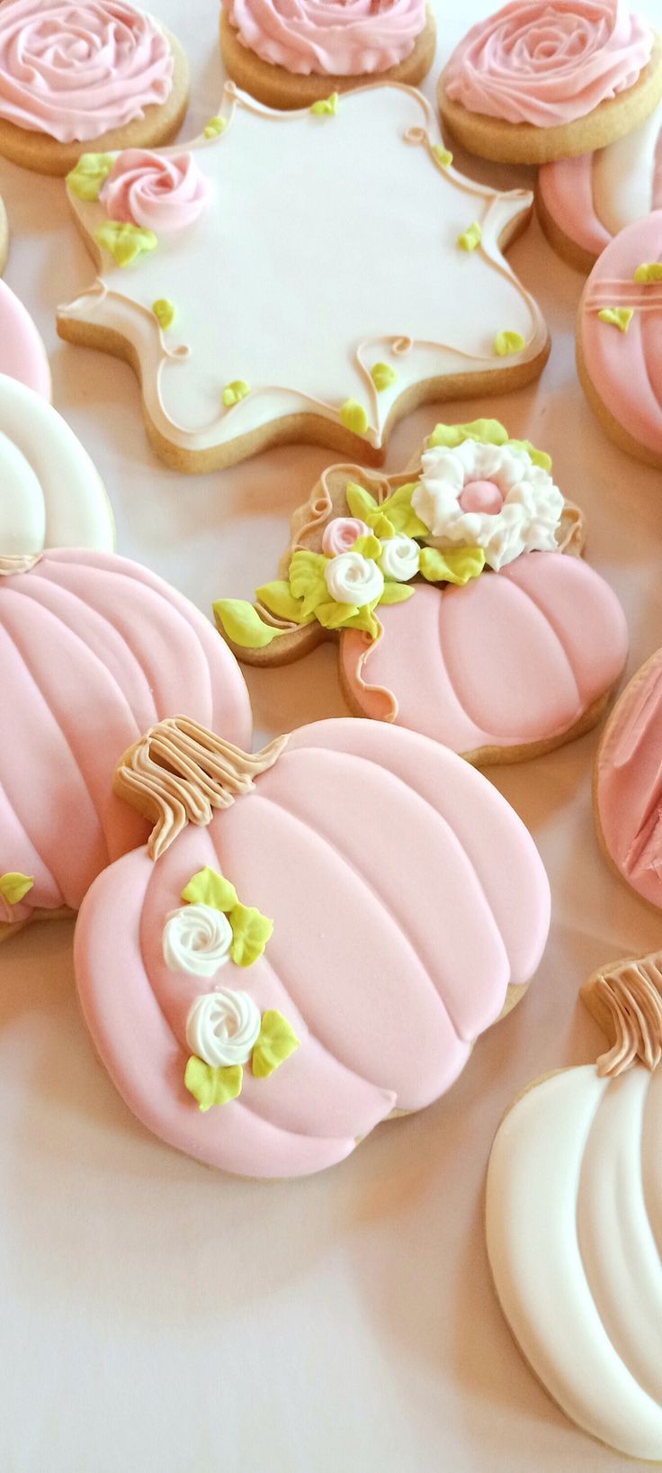 Charming Pastel Cookie Designs with Floral and Pumpkin Accents for Celebrations.