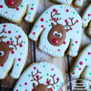 Cheerful Sweater-Shaped Festive Cookies with Playful Reindeer Designs.