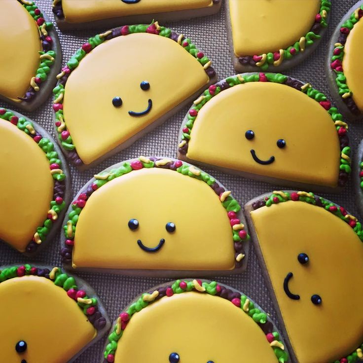 Cheerful Taco-Shaped Cookies with Vibrant Yellow Icing and Playful Designs.