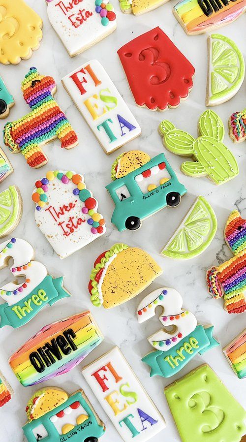 Vibrant Festive Cookie Assortment Featuring Tacos, Pinatas, and Cacti Designs.