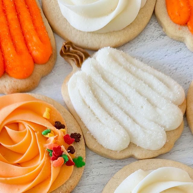 Vibrantly Decorated Autumn Cookies: Festive Designs in Pumpkin Shapes with Colorful Frosting.