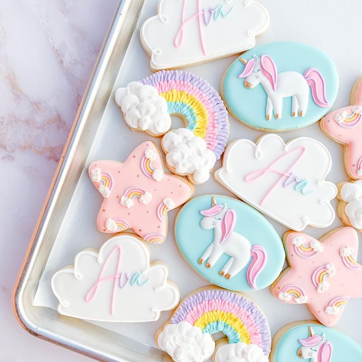 Playful Whimsical Cookie Designs: Enchanting Unicorns and Rainbows in Soft Pastels.