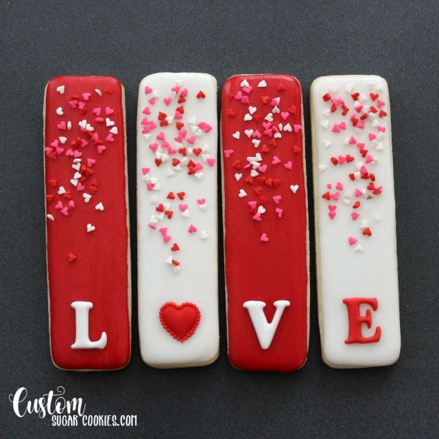 Valentine's Day Heart-Themed Cookies: Festive Red and White Iced Delights Adorned with Colorful Sprinkles.