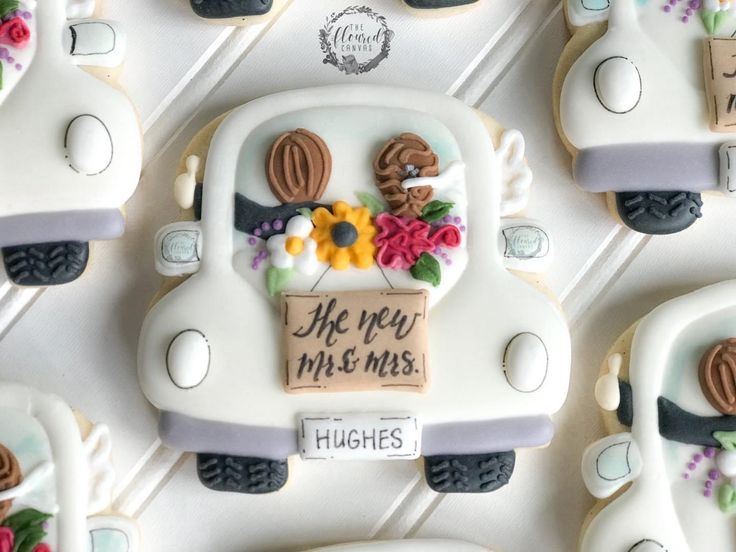 Whimsical Vintage Car-Shaped Cookies Adorned with Colorful Flowers for Celebratory Events.