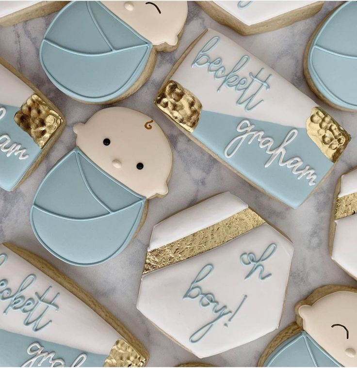 Charming Baby Motif Decorative Cookies with Gold Accents for Celebrations.