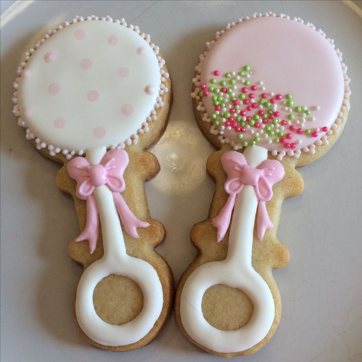 Charming Pastel Decorative Baby Rattle Cookies with Intricate Icing for Celebrations.