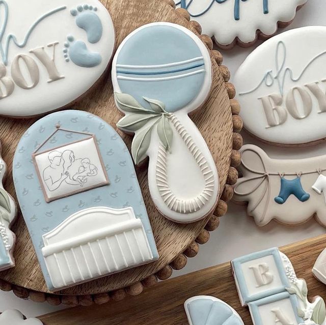 Charming Baby-Themed Decorative Cookies in Soft Blue and White.