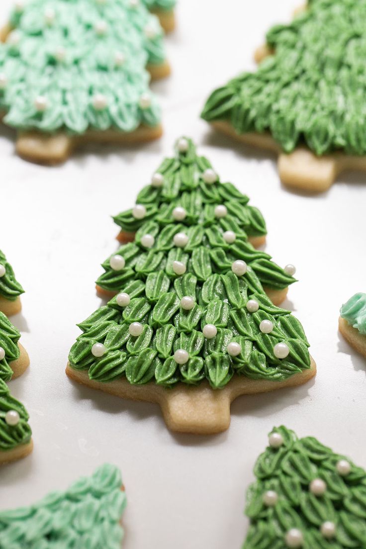 Charming Christmas Tree Cookies with Elegant Green Icing and Pearl Accents.