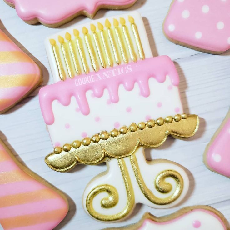 Festive Colorful Birthday Cake Cookies with Pink Icing and Decorative Accents.