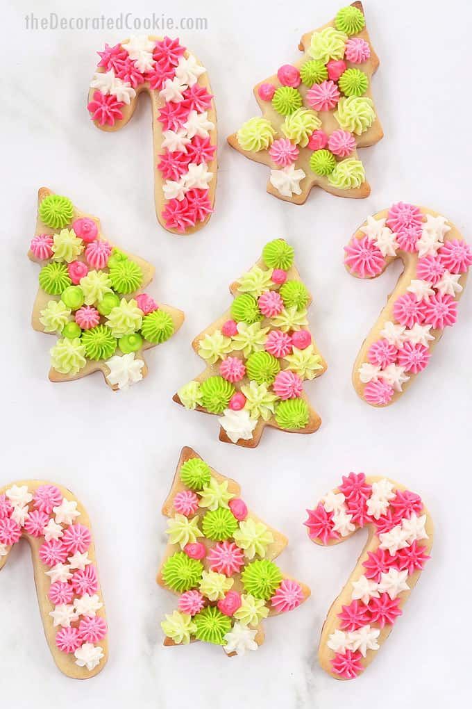 Festive Decorated Cookies with Whimsical Designs in Pink and Green Frosting.