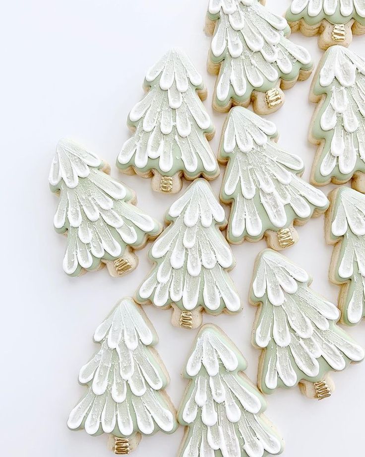 Intricate Holiday Nail Designs with Soft Green and White Tree Motifs