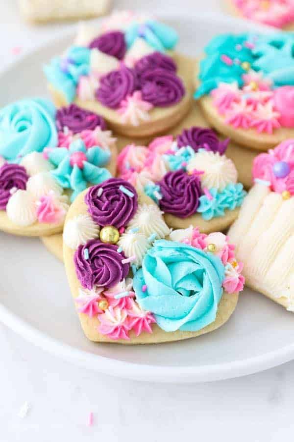 Playful Heart-Shaped Floral Cookies Adorned with Vibrant Icing and Decorative Elements.