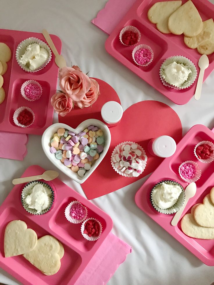 Romantic Dessert Setup: Heart-Shaped Trays and Pastel Treats for Celebrations.